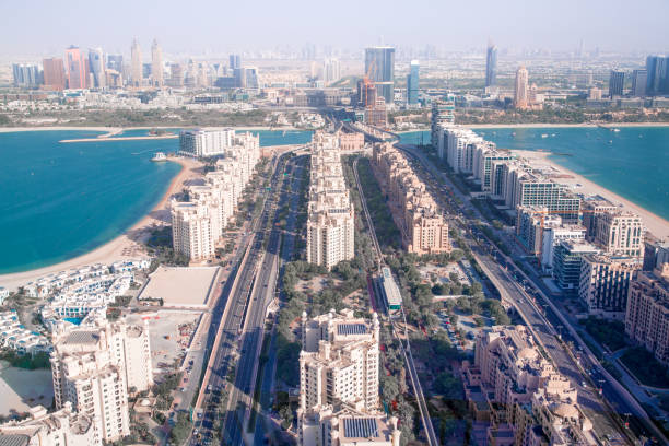 Aerial view of luxurious residential areas in Dubai, showcasing high-end buildings and scenic waterfronts.