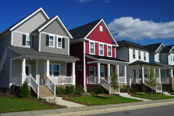 A row of colorful, modern houses under a clear blue sky.